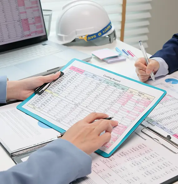 Two professionals reviewing costing-related documents for an Individual income tax preparation in Billings, MT